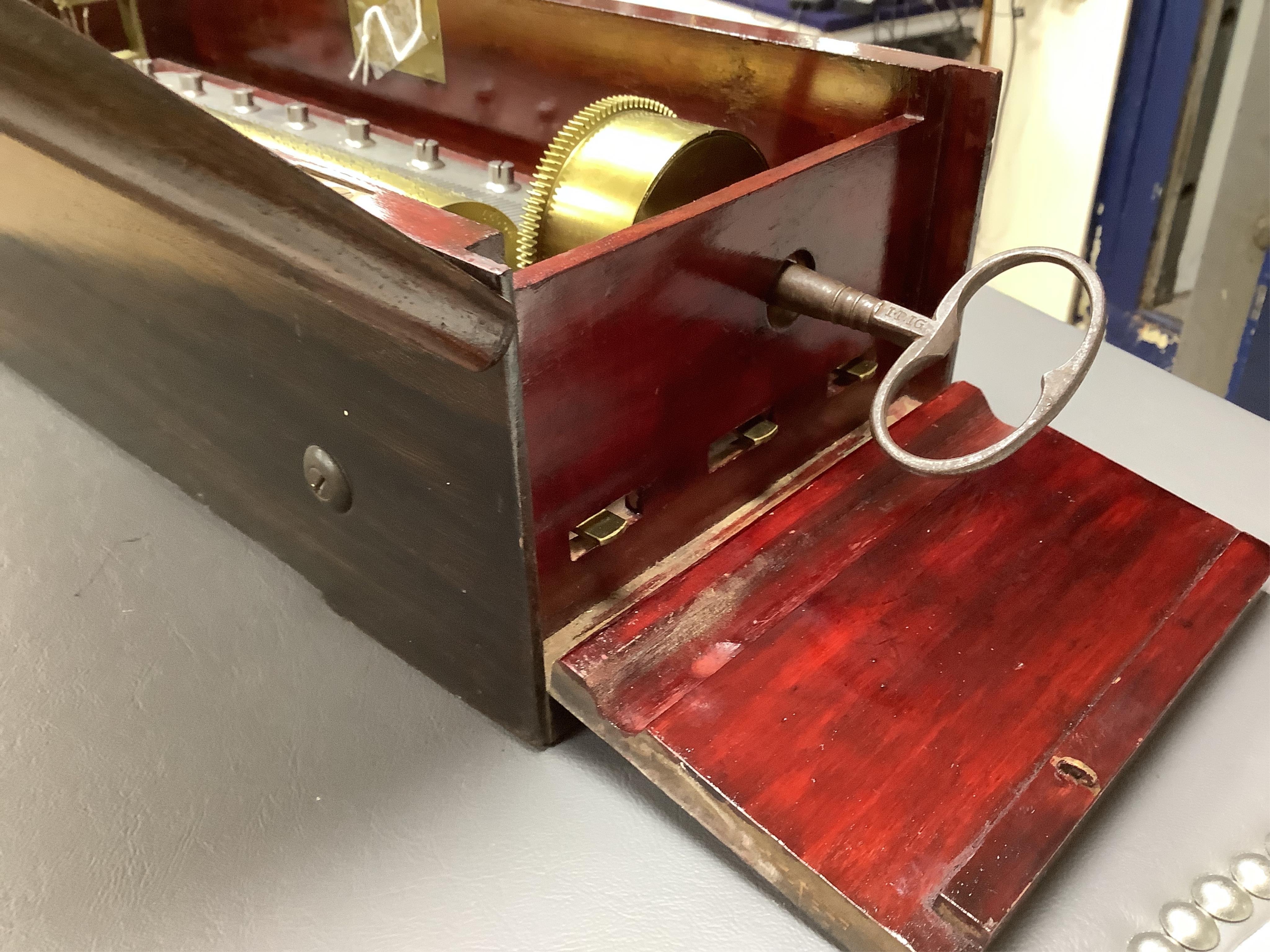A mid 19th century Nicole Freres key wound cylinder musical box in an inlaid rosewood case, playing on approx 105 tooth comb, cylinder 27.5cm long, stamped ‘Nicole Frere a Geneve’, 26927, with key, the case; 45.5cm wide,